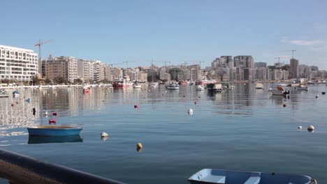 Small-blue-fisherman-boat-floating-in-calm-sea-waterfront