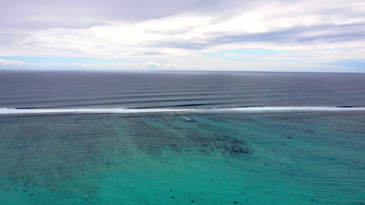 Aerial View of Turquoise Ocean Waves Breaking on a Coral Reef