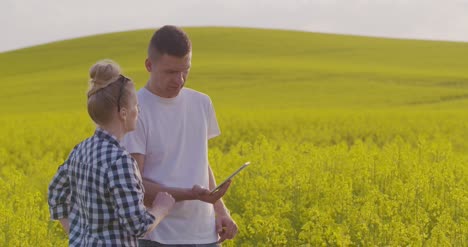 farmers discussing while using tablet computer at farm 3