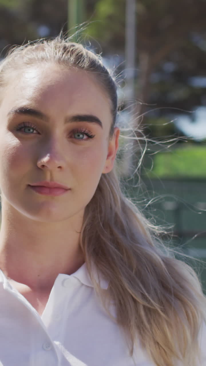 video de una tenista caucásica sosteniendo una raqueta y mirando a la cámara