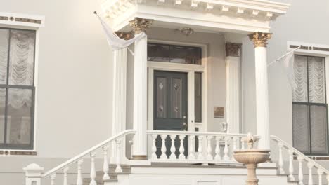 frontal external view of door with stylish white columns