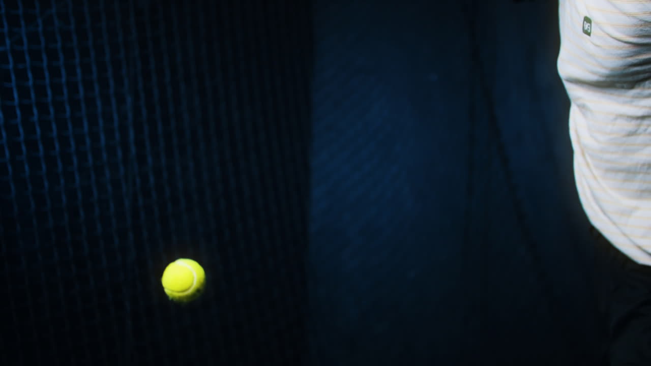 Male athlete serving in paddle tennis. Slow motion close up