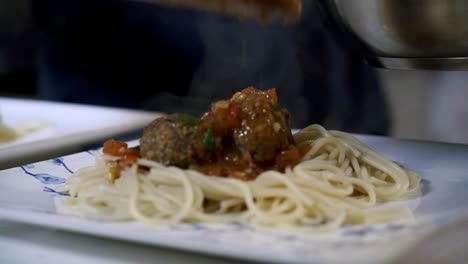 adding sauce to meatballs plating vegan meatballs preparing ingredients to make vegan beyond meatballs with spaghetti and meat sauce