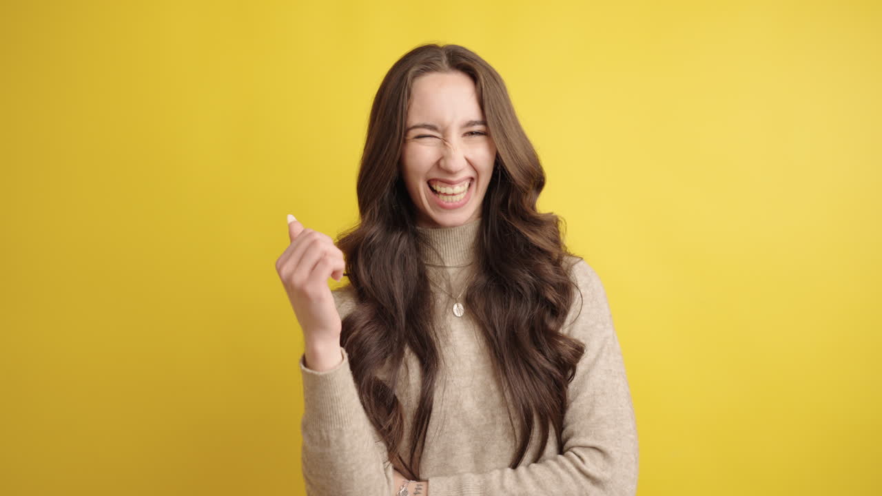 Woman shifting from thoughtful to playful expressions on yellow background