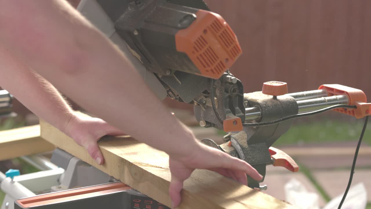Slow motion shot of a carpenter readjusting the wood to cut on the line