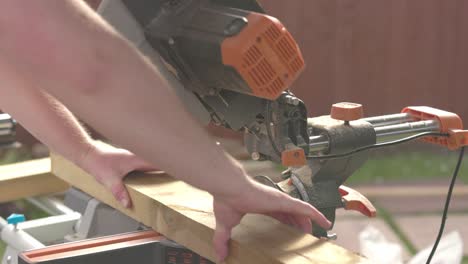 slow motion shot of a carpenter readjusting the wood to cut on the line