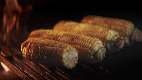 delicious cobs of corn are fried on a hot grill grill