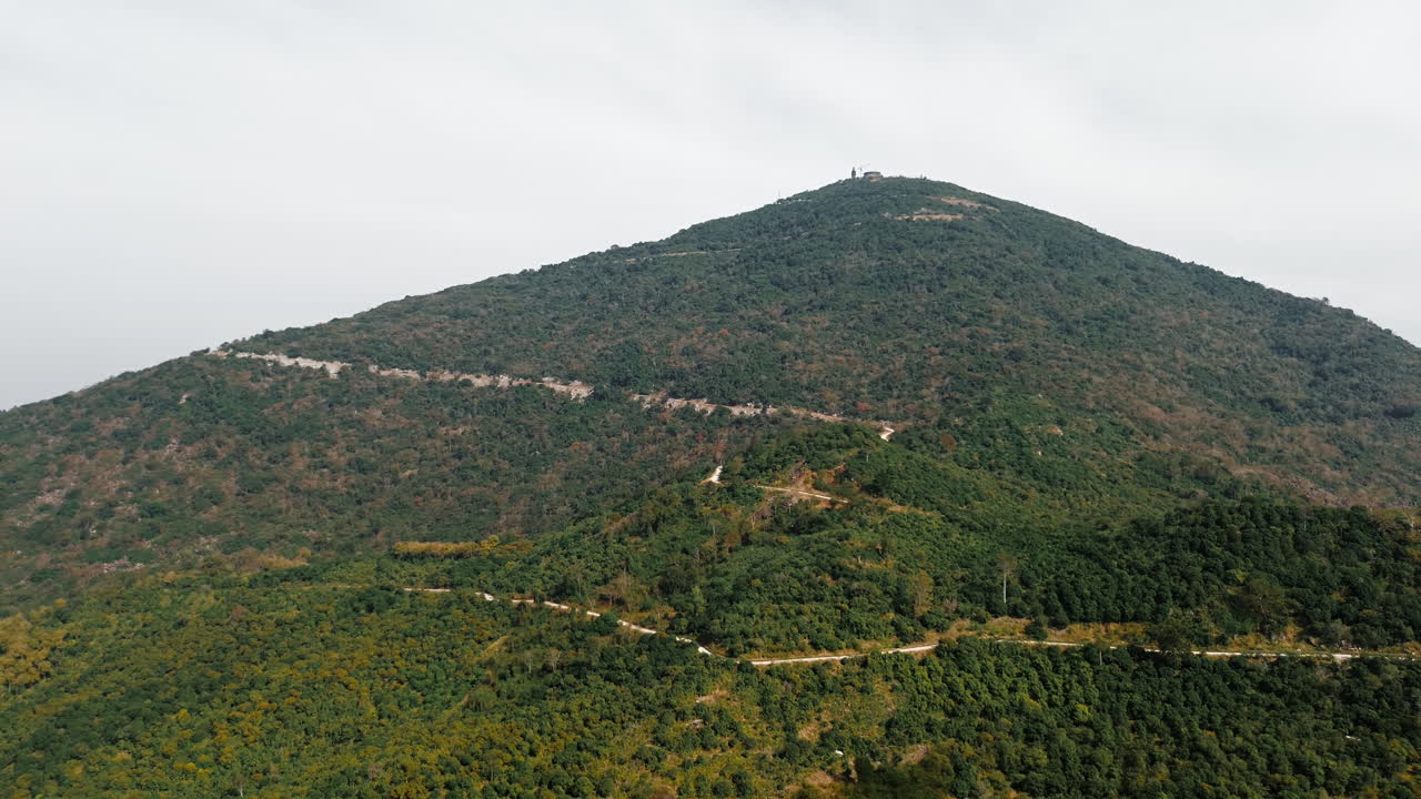 Steep mountain landscape with winding road and lush forest in Tay Ninh, South Vietnam