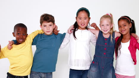 cute children smiling at camera and showing thumbs up