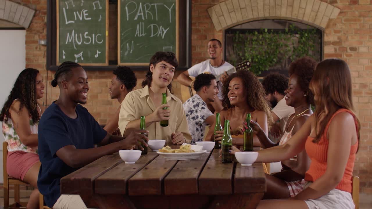 Friends Enjoying a Lively Outdoor Party with Live Music and Drinks