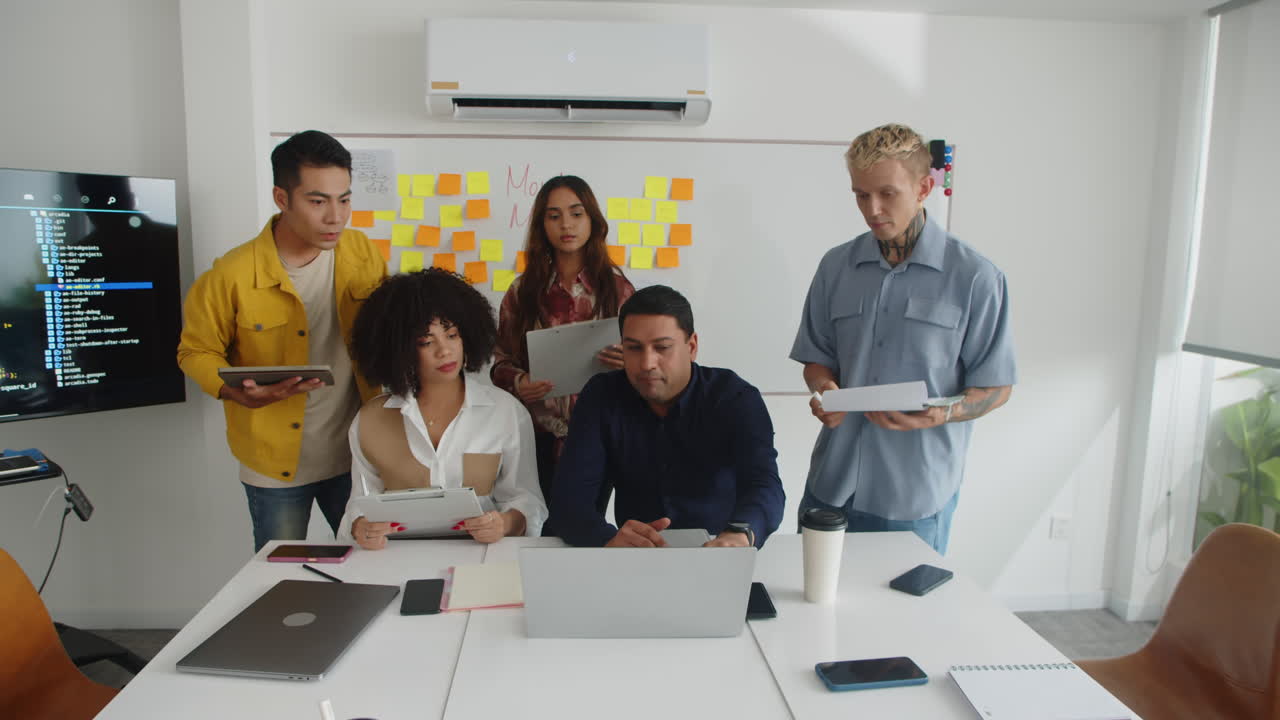 Manager Showing New App Design to Team at Meeting