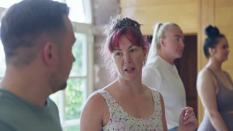 people having conversation at yoga class