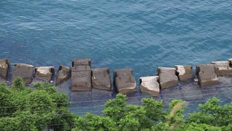 Stones-and-rocks-placed-in-the-sea-near-the-coast-as-an-erosion-prevention-system,-located-in-Batumi,-Georgia,-highlighting-the-concept-of-coastal-protection-and-environmental-management