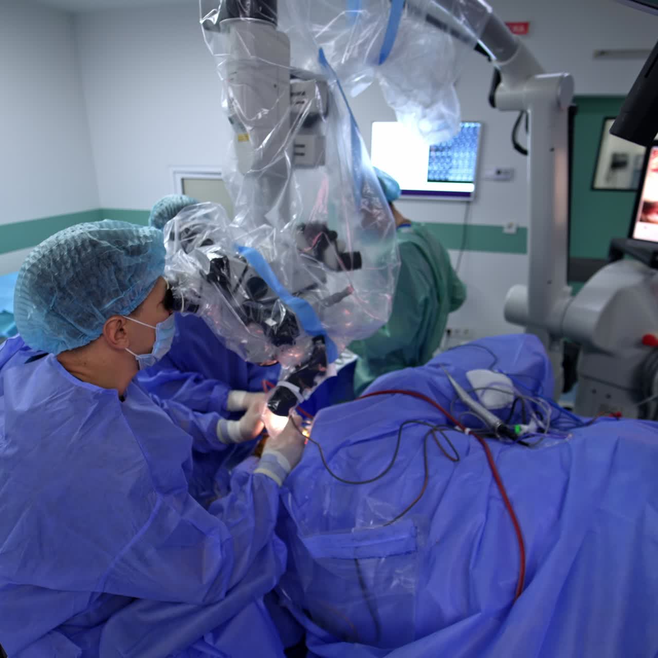 High-precise neurosurgery involving the usage of powerful microscope. Focused doctor applying electric tools looking at binoculars of modern equipment. Top view