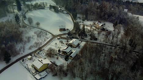 Aerial-shot-of-a-snow-covered-mountain-town-in-fog