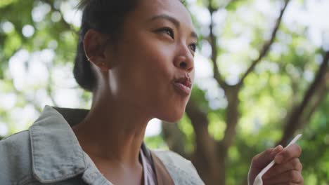 mixed race woman eating on the street