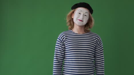 mime man waving hand over green background