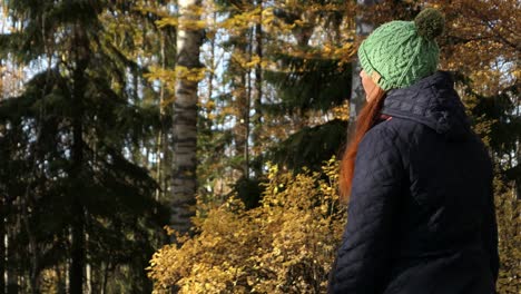 Woman-sitting-peacefully-in-forest-in-fall,-ecological-lifestyle