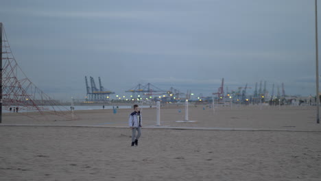 niño caminando por la playa en un día frío