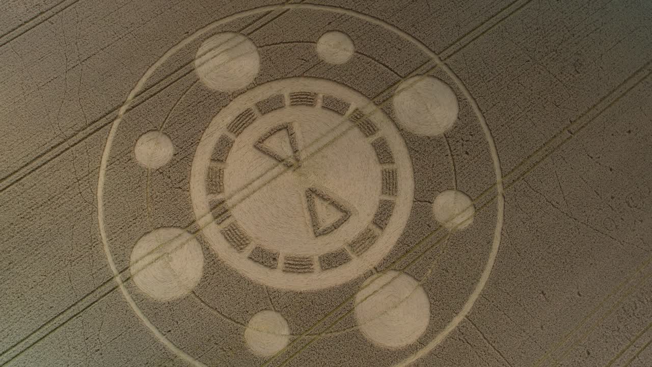 Swarraton barley field geometric crop circle pattern aerial rotating drone view above Hampshire countryside