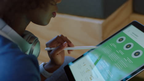 young black business woman using tablet browsing corporate project documents on portable computer technology colleagues working together in brainstorming in office