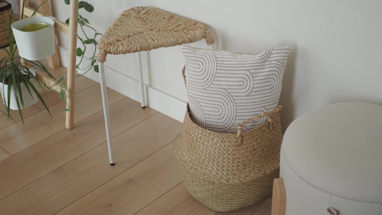 Decorative Woven Basket with Patterned Pillow in Minimalist Interior