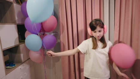 girl with balloons at birthday party