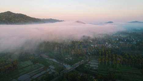 aerial view. flying over the village and fog in the morning. dramatic and beautiful