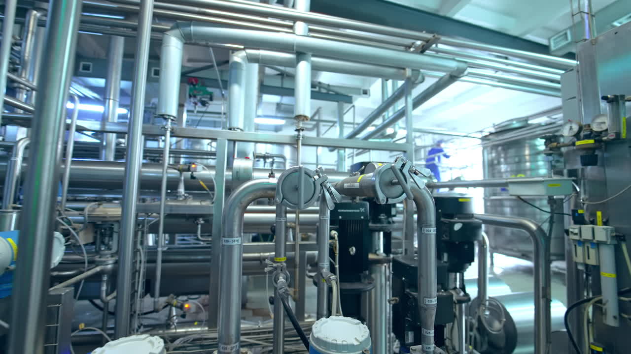 Production of yogurt and milk at dairy factory, industrial equipment for filling plastic cups and bottles