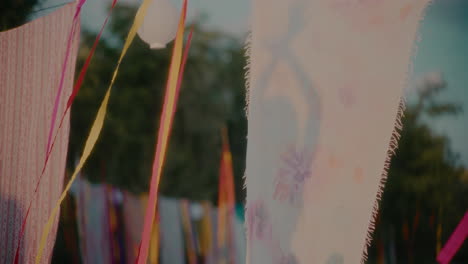 dancing woman's shadow on sarongs hanging by ribbons