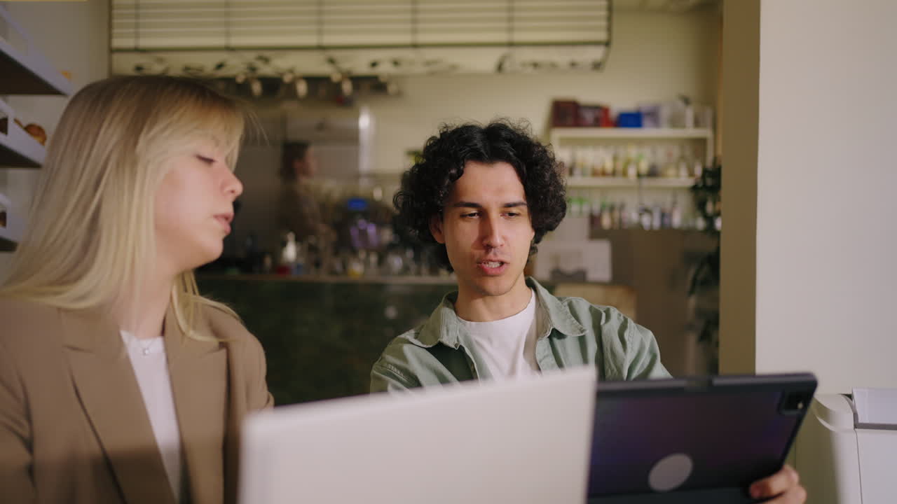 Two people having a business meeting in a cafe