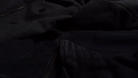 close up zipper on black jeans. men's clothing. unzipped. dark pants. male fashion.