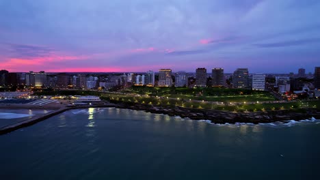 aerial of vibrant sunset over mar del plata and san martin park, argentina