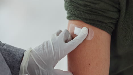 applying a bandage after vaccination