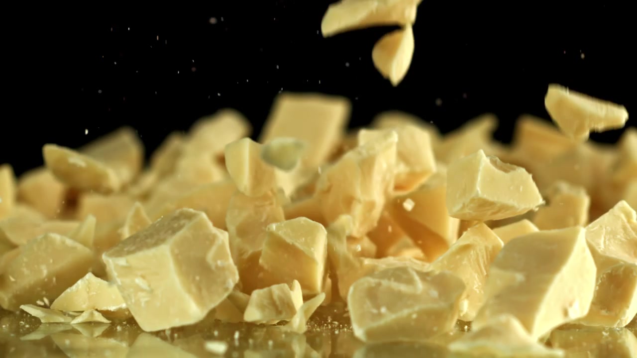 White Chocolate Pieces Falling in Slow Motion