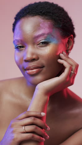 vertical video of african american woman with short dark hair in blue and pink light, slow motion