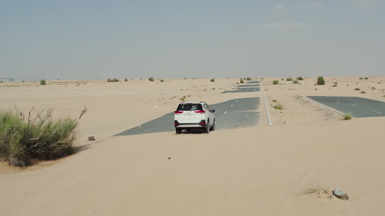 suv blanco conduciendo en un camino del desierto
