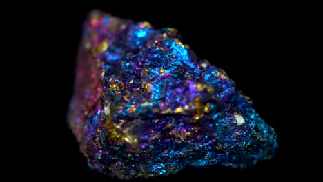 seamlessly rotating a colorful mineral (bornite) in front of black background