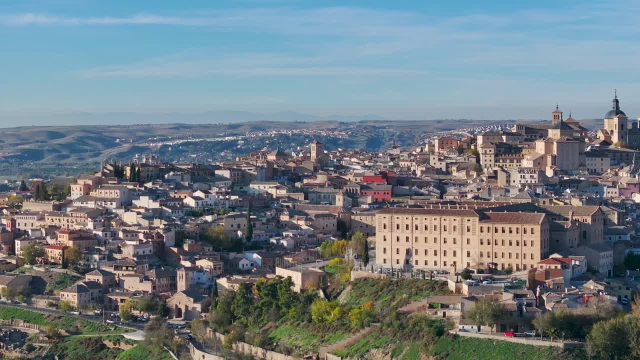 Aerial drone sweeping right across Toledo, Spain, capturing the city’s historic buildings, Cathedral, Alcázar, and medieval streets, with panoramic views under a clear autumn sky