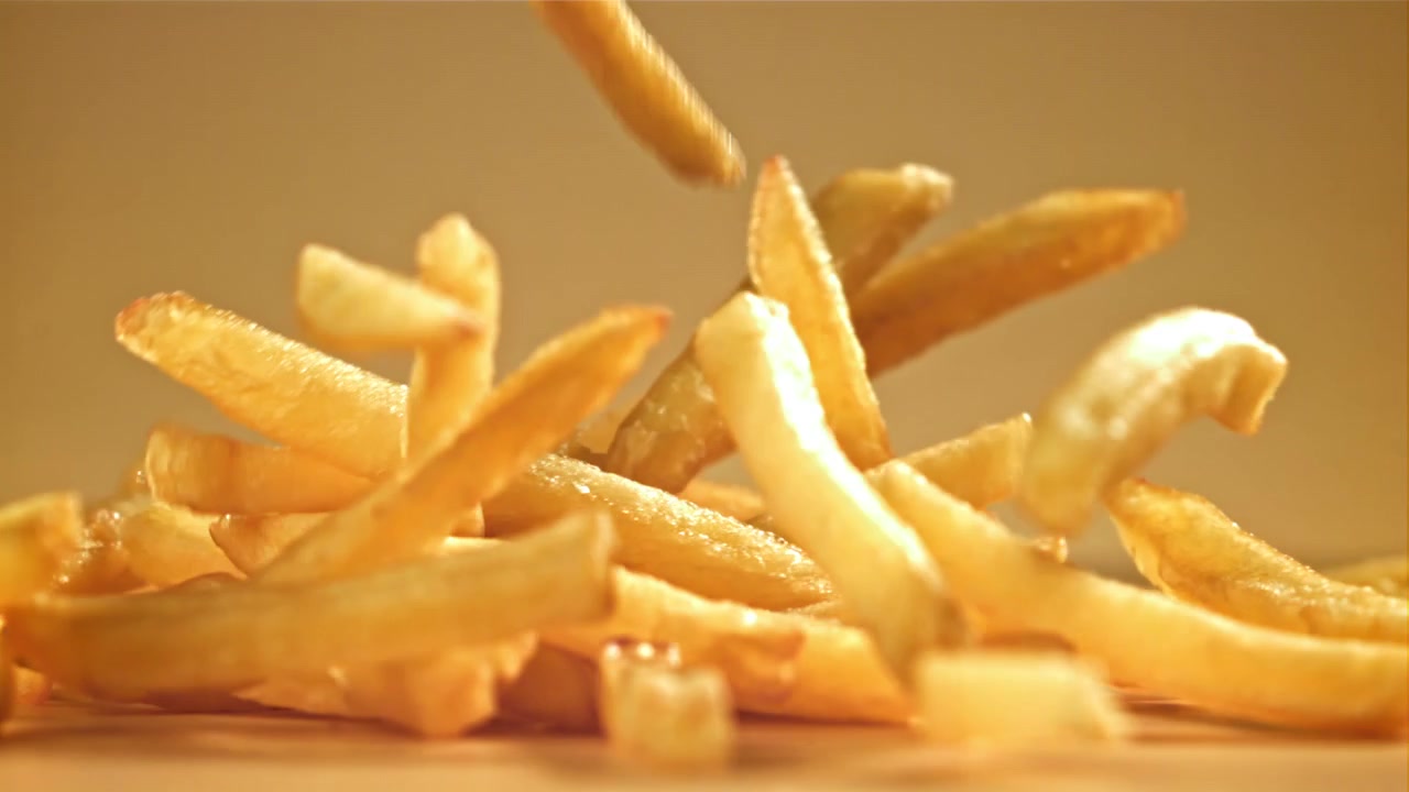 Golden French Fries Falling in Slow Motion