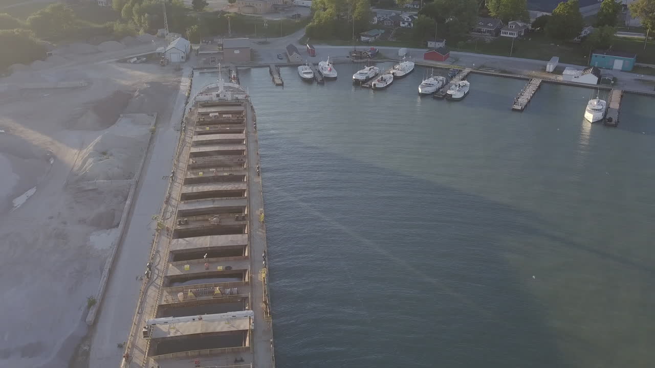 Yachts Docked At The Sea Port Near The Sand Dredging Vessel At The Reclamation Area In Kingsville, Ontario, Canada - aerial drone shot