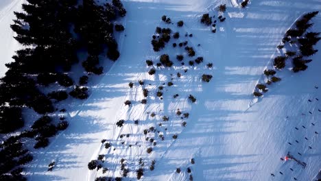 Aerial-view-of-the-ski-lift-at-the-foot-of-the-ski-slope-with-a-crowd-of-skiers-and-snowboarders