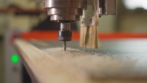 lathe machine head with drill goes down and carves plywood