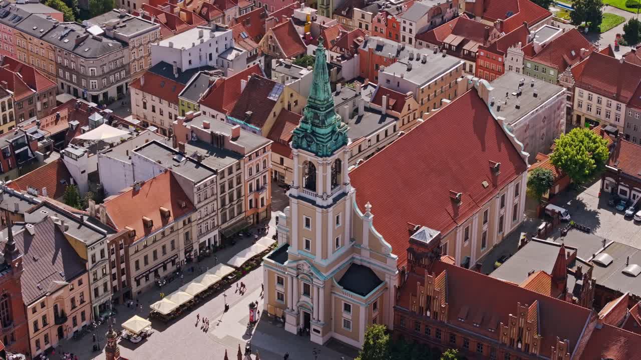 Cinematic aerial view captures baroque church amid Torun’s old town beauty