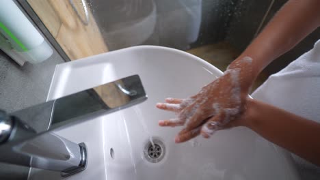 washing hands in a bathroom sink