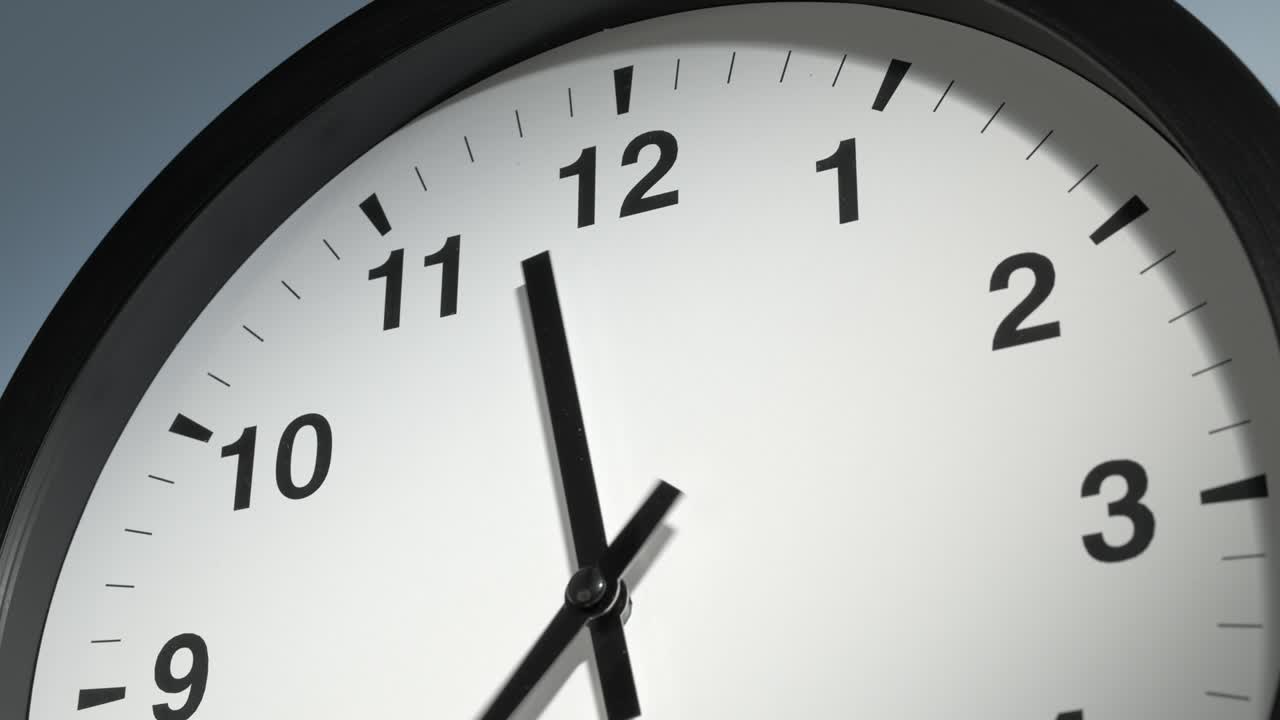 Clock Face on Light Blue Wall in Time Lapse