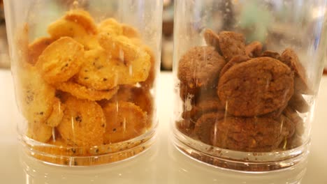 close up of sweet cookies in a glass jar at cafe ,