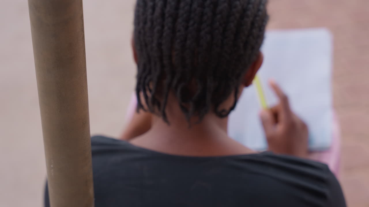 Student notes focus. Outdoor student preparing diligently. Braidedhaired girl studying with determination outside. Focused student with highlighter on bench prepares for exams diligently