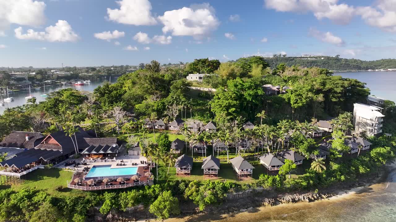 Drone pull back from Iririki Resort Island on Vanuatu shore. Pacific, Polynesia travel destination