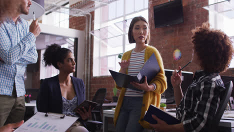 diverse group of work colleagues having a meeting and discussion in the office